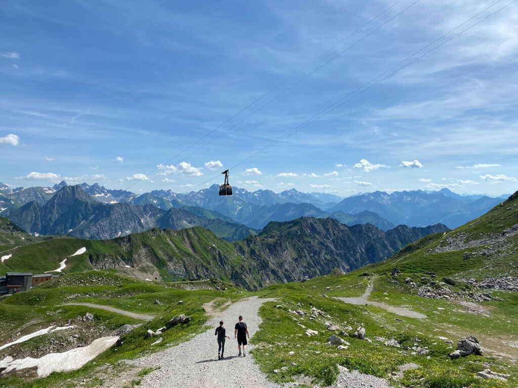 Two hikers descending from Nebelhorn with brilliant alpine ranges