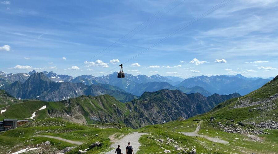 Two hikers descending from Nebelhorn with brilliant alpine ranges