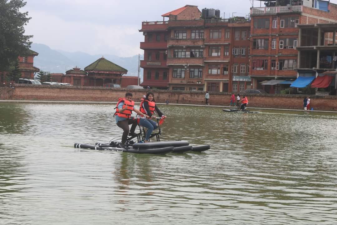 a boy and a girl watercycling together in bhaktapur napukhu pond